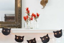 23 a black cat garland with lights is a stylish idea for Halloween, it looks cool and bold and isn’t difficult to make