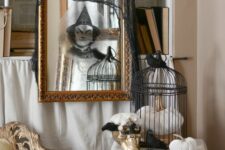 23 a mirror in a vintage gilded frame with a ghost sticker and a black cheesecloth piece is great for Halloween