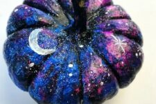 23 a small black, blue and hot pink pumpkin with white spot stars, large stars and moons for Halloween decor