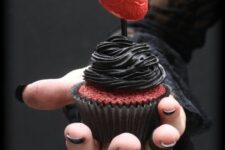24 a red velvet cupcake topped with black chocolate frosting and a red heart looks absolutely jaw-dropping