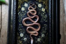 25 a beautiful Halloween artwork with dried blooms and a copper snake is a cool and chic idea for Gothic home decor