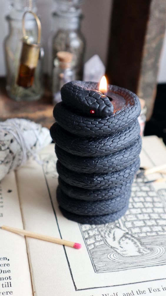 A black snake shaped candle is a unique solution for Halloween decor, it looks wow