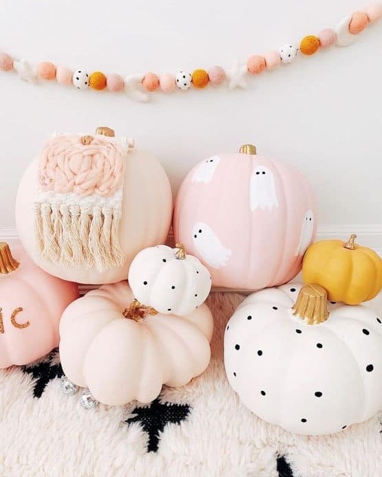 an arrangement of cool blush and white pumpkins, with polka dots, ghosts and macrame is amazing