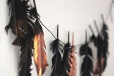 28 a chic Halloween garland of black and black gilded feathers is a cool idea for Halloween decor, it will fit a boho space