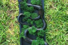 28 a creative Halloween wall art piece of a frame with moss and black snakes is an easy DIY