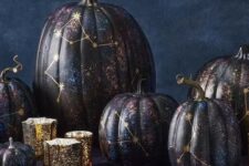 28 an arrangement of jaw-dropping black, purple and blue constellation pumpkins with gold constellations is fantastic