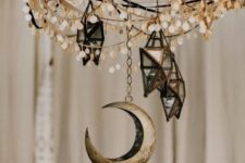 29 a chandelier with coins, 3D star candleholders and a moon will make your space very boho and celestial