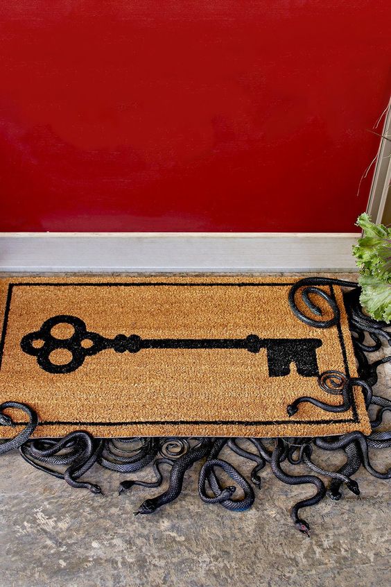 a door mat with small snakes underneath is a cool idea for Halloween porches