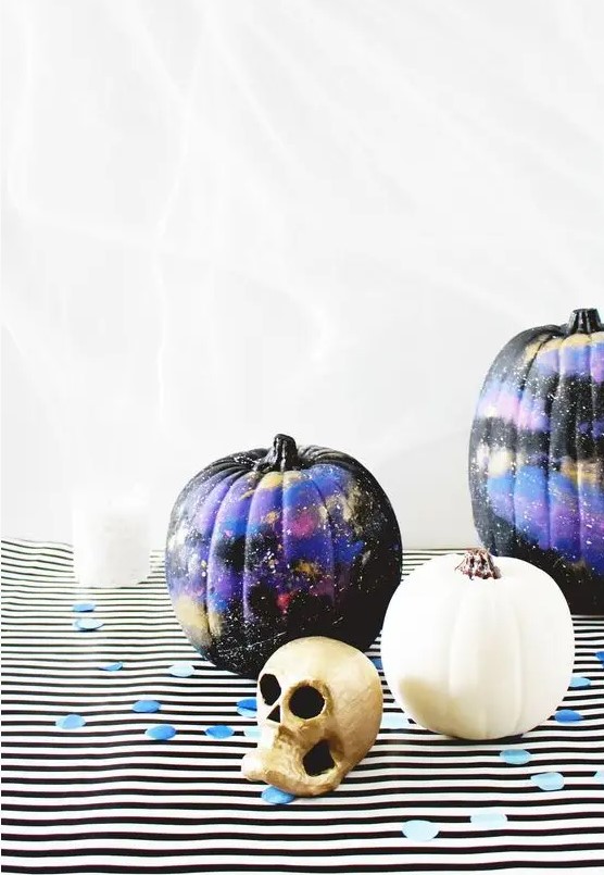 Black, purple and gold galaxy themed pumpkins are amazing for Halloween, bold, catchy and mysterious