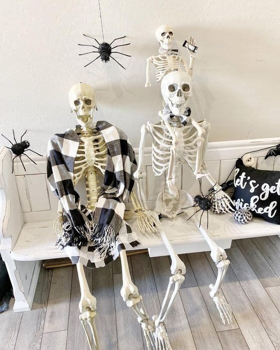 skeletons on your entryway bench, with spiders around and a pillow will instantly make your entryway Halloween-like