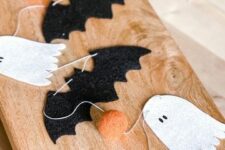 30 a cool woolen Halloween garland with ghosts, bats and pompoms is a cute decoration for Halloween