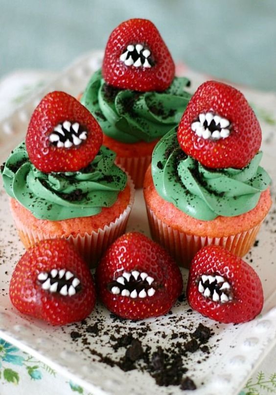 bright and spooky Halloween cupcakes with green toppings, red strawberries with teeth are great for Halloween