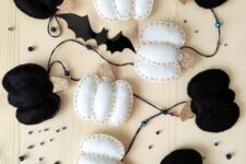 33 a gorgeous felt garland with black and white pumpkins, bats and spiderwebs is a cool solution for Halloween