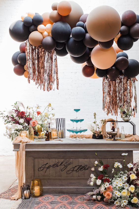 A jaw dropping celestial Halloween bar with chic floral arrangements, a balloon installation with frigne and cocktails