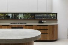 34 a minimalist kitchen with stained and sleek white curved cabinets, a window backsplash and a curved kitchen island with a stone countertop
