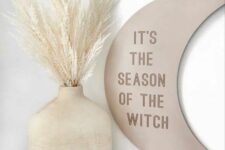 34 a moon sign with some words is a cool neutral Halloween party idea with a celestial touch
