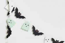 35 a Halloween garland of black bats and mint green and white ghosts is a cool and easy decor idea for your space