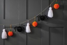 36 a Halloween garland of white tassels as ghosts, black spiders and orange pumpkin pompoms is a cool idea for styling a kids’ party