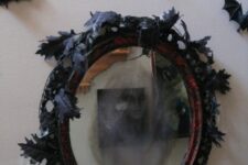 37 a Halloween mirror with a ghost inside, black leaves and black bats around are a great combo to rock