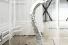 38 a white snake in a cloche is an elegant and scary Halloween decoration you can make