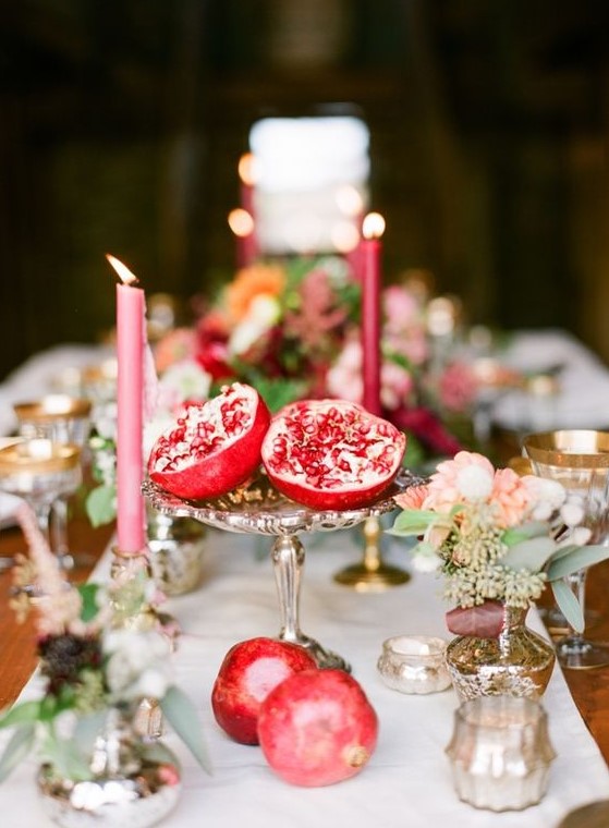 make easy centerpieces just cutting pomegranates in halves and placing them on stands