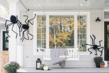 40 a house styled with giant black spiders looks scary and Halloween-like but still remains a farmhouse-style dwelling with an organic and natural feel