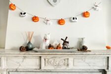 40 a lovely 3D Halloween garland with pumpkins, Jack Skellington faces and little ghost dogs is a stylish and cool idea for Halloween
