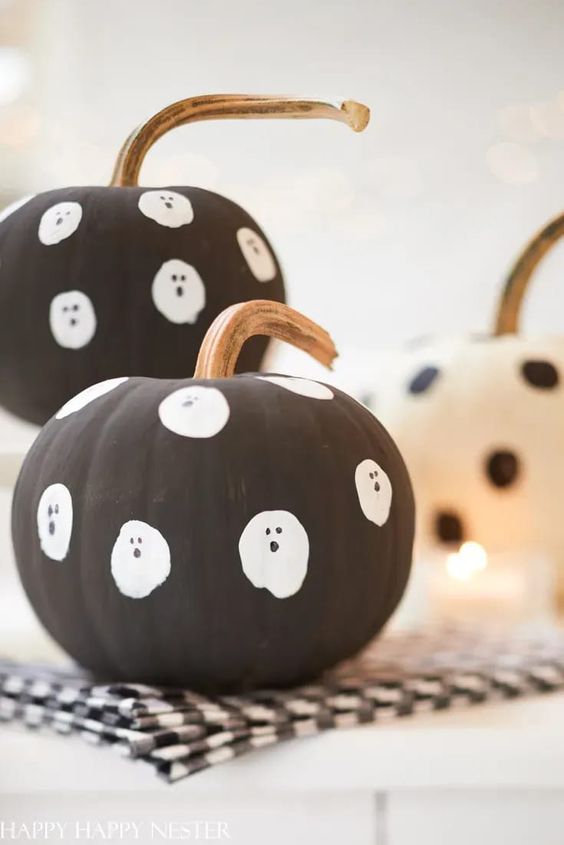 make some easy matte black pumpkins with ghosts for your kids' Halloween party