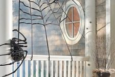 42 a spiderweb with skeleton spiders is a nice scene for your Halloween front porch