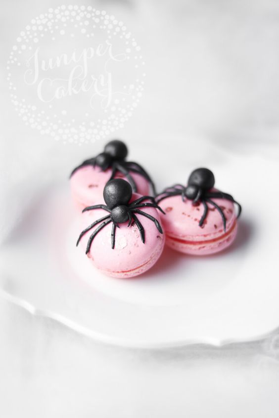 pink macarons with creepy black fondant spiders are amazing Halloween desserts to rock
