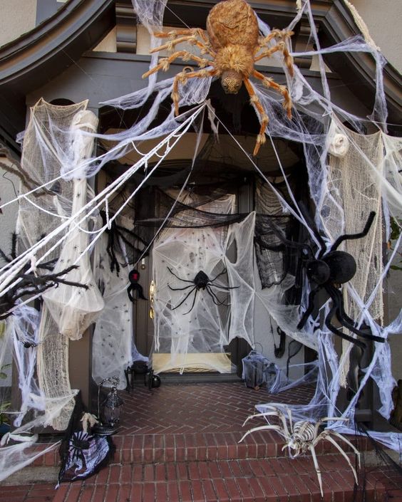 An entrance to the house completely covered with spiders all over and spiderweb looks really scary and Halloween like