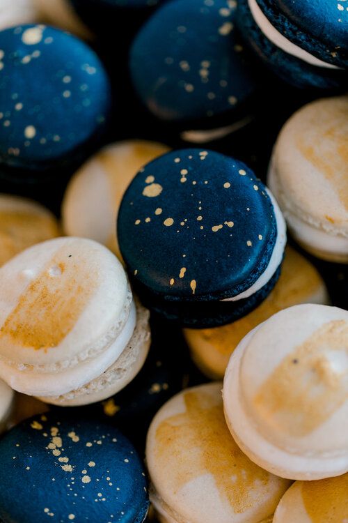 blue and gold splatter and white with gold touches macarons will be nice favors or desserts at a celestial Halloween party