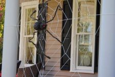 45 decorate your front porch with a giant spiderweb and a black spider and you will get a Halloween porch at once, without additional decor