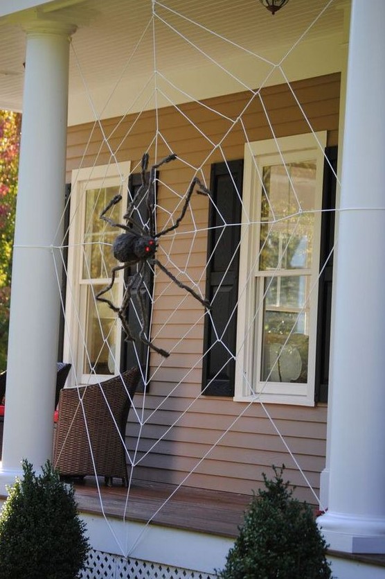 decorate your front porch with a giant spiderweb and a black spider and you will get a Halloween porch at once, without additional decor