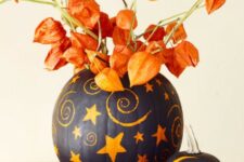 45 painted pumpkins with dried blooms that match will make up a bold and super catchy Halloween centerpiece