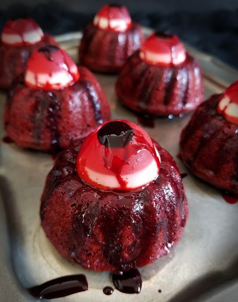red velvet cakes with eyeballs on top and some chocolate sauce are great as Halloween desserts