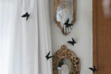 45 small mirrors in vintage frames with ghost hands and black butterflies around is a cool and bold idea