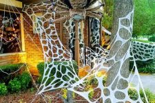 46 faux spiderweb and an oversized and scary spider are amazing to style your outdoors or front porch for Halloween and are cool