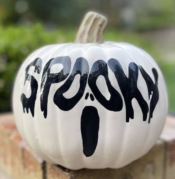 a black and white Halloween pumpkin done with simple black and white paint is a cool and catchy decor idea