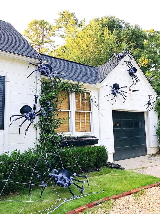 giant black spiders with a touch of fluff and spiderweb are great for styling your home outdoors, attach them to the walls and ground