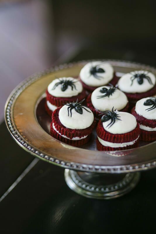 red velvet mini cakes with frosting and black chocolate spiders on top will be amazing wedding desserts or favors for a Halloween party