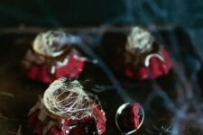48 red velvet molten lava cakes with chocolate ganache and spun sugar on top for a Halloween party