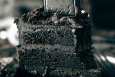 50 a black chocolate cake topped with a tombstone is a lovely idea, dark chocolate buttercream frosting makes it even more delicious