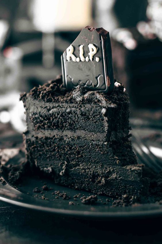 a black chocolate cake topped with a tombstone is a lovely idea, dark chocolate buttercream frosting makes it even more delicious