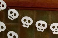 50 a super easy to make white paper skull garland will help you decorate a mantel, a porch, an entryway or any other space