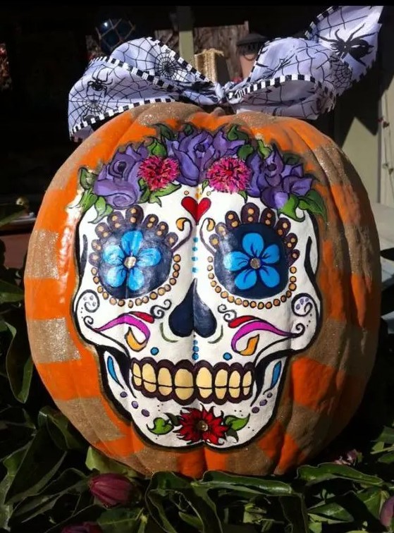 a colorful sugar skull Halloween pumpkin is a creative idea for those who don't want to carve but have good painting skills