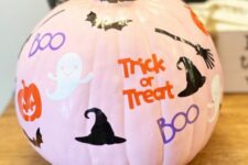 53 a pink pumpkin with ghosts, pumpkins, bats, witches’ hats and brooms plus colorful letters is a cool solution