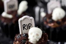 53 сhocolate graveyard cupcakes topped with chocolate frosting and edible graveyard decorations
