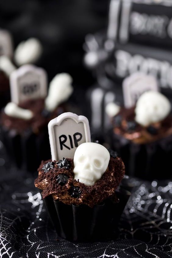 сhocolate graveyard cupcakes topped with chocolate frosting and edible graveyard decorations