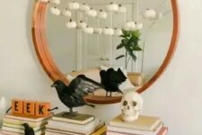 61 stylish minimalist Halloween decor with blackbirds, a skull and a garland of mini white pumpkins is very chic and cool
